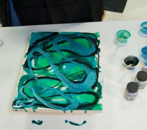 Image of canvas with aqua colored resin has some Pearl Ex mica pigment mixed in for some shimmer.