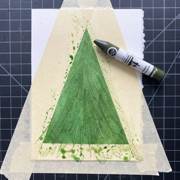 Green watercolor stick marks over green watercolor wash within masking taped triangle on small watercolor sheet. Green watercolor stick off to side.